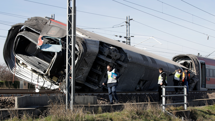 Police inspect an overturned carriage of a high-speed train after it derailed near the town of Lodi, Italy, Feb. 6, 2020.