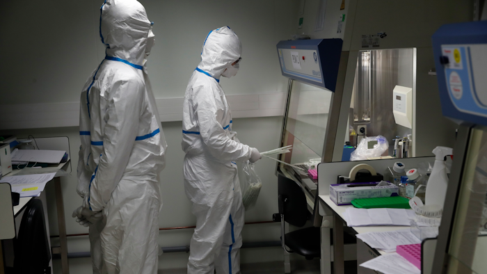 French scientists manipulate patient samples at the Pasteur Institute in Paris, Feb. 6, 2020.