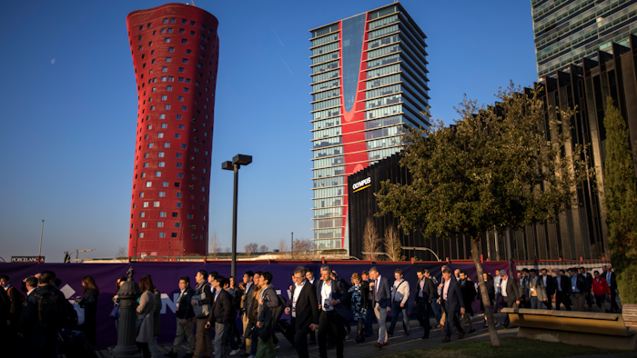 Attendees walk to enter the Mobile World Congress wireless show in Barcelona, Feb. 25, 2019.