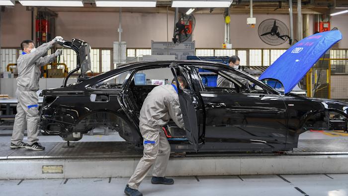 Workers assemble Audi A6 L cars at a workshop of FAW-Volkswagen Automobile Co., Ltd. in Changchun, China, Feb. 17, 2020.