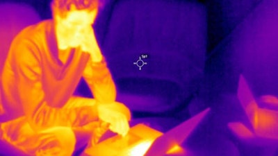 Image showing the difference in thermal radiation and temperature between a person and surfaces.