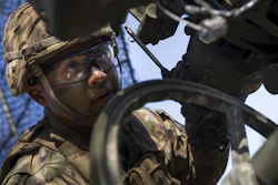 Sgt. Johnny Bonilla, a gunner and cannon crewmember with the 173rd Airborne Brigade, wears a combat helmet first fielded in the 1980s.