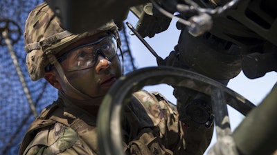 Sgt. Johnny Bonilla, a gunner and cannon crewmember with the 173rd Airborne Brigade, wears a combat helmet first fielded in the 1980s.