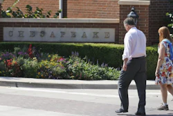 In this Sept. 29, 2015, file photo, two people walk past an entrance to the Chesapeake Energy Corp. campus in Oklahoma City.