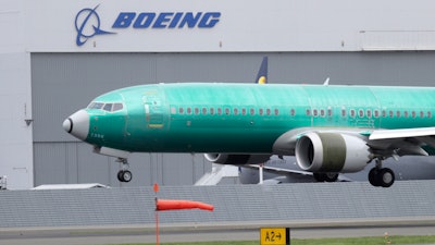 In this April 10, 2019, file photo, a Boeing 737 Max 8 airplane lands following a test flight at Boeing Field in Seattle.