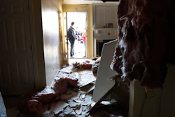 Houston Fire Chief Samuel Peña talks with Hortensia Lima, whose home was seriously damaged, Jan. 26, 2020.