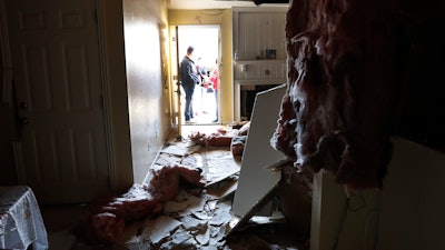 Houston Fire Chief Samuel Peña talks with Hortensia Lima, whose home was seriously damaged, Jan. 26, 2020.