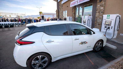 A Nissan Leaf electric vehicle charges at the Eagle's Landing Travel Plaza, Mesquite, Nev., Jan. 29, 2020.