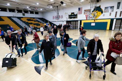 Local residents enter an Iowa Democratic caucus at Hoover High School, Feb. 3, 2020, in Des Moines.