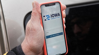 Precinct captain Carl Voss displays the Iowa Democratic Party caucus reporting app in Des Moines, Feb. 4, 2020.