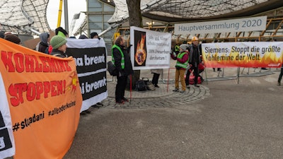 Climate activists demonstrate outside the Olympic Hall during Siemens' annual shareholders' meeting in Munich, Feb. 5, 2020.