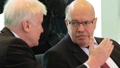German Interior Minister Horst Seehofer, left, talks with Economy Minister Peter Altmaier at the chancellery in Berlin, Feb. 5, 2020.