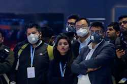 Delegates wear face mask as they attend an event at the Auto Expo in Greater Noida, India, Feb. 5, 2020.