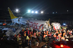 Rescue members and firefighters work around the wreckage of a plane after it skidded off the runway at Istanbul's Sabiha Gokcen Airport, Feb. 5, 2020.