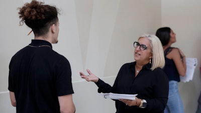 In this Oct. 1, 2019, file photo, Gory Rodriguez of Starbucks, right, interviews a job applicant during a job fair at Dolphin Mall in Miami