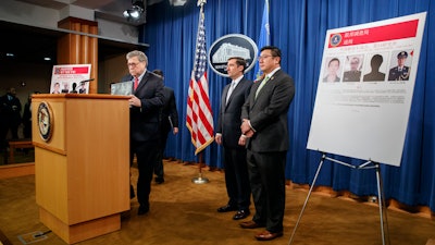 Attorney General William Barr, left, Assistant Attorney General John Demers and U.S. Attorney for the Northern District of Georgia Byung 'BJay' Pak, right, at the Justice Department in Washington, Feb. 10, 2020.