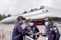 Royal Malaysian Air Force personnel wear masks at the Static Aircraft Display area at the Singapore Air Show, Feb. 11, 2020.
