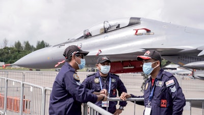 Royal Malaysian Air Force personnel wear masks at the Static Aircraft Display area at the Singapore Air Show, Feb. 11, 2020.