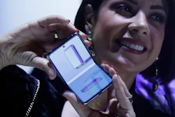 A woman holds a Samsung Galaxy Z Flip Phone at the Unpacked 2020 event in San Francisco, Feb. 11, 2020.