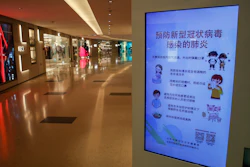 In this Feb. 9, 2020, file photo, an electronic display board shows a precautionary notice of the coronavirus at a deserted upscale shopping mall in Beijing.