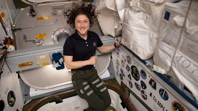 Astronaut Christina Koch in the vestibule between a SpaceX Dragon cargo craft and the Harmony module of the International Space Station, June 2019.