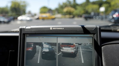 A police vehicle reads the license plates of cars in a parking lot in San Marcos, Calif., Sept.17, 2014.