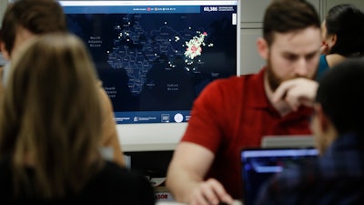 Kyle Martin, a worker at HealthMap, mines health data at Boston Children's Hospital, Feb. 13, 2020.