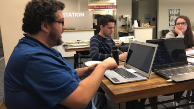 Energy industry software specialist Ryan Mohrman, left, information system developer Ariel Lasry, center, and coder Kelsi Hoyle at a Code For Denver meeting in Denver, Jan. 13, 2020.