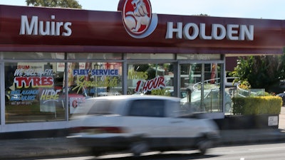A car drives past a dealership of Holden, General Motors' Australian subsidiary, in Sydney, Dec. 11, 2013.