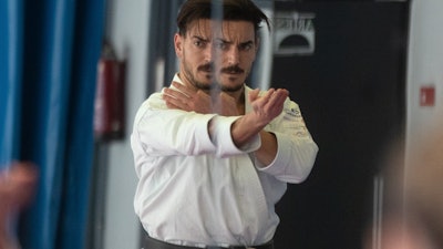 Spanish karate athlete Damian Quinteros is reflected in a large mirror as he trains in Madrid, Feb. 7, 2020.