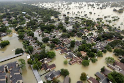 Water from the Addicks Reservoir flows into neighborhoods from floodwaters brought on by Tropical Storm Harvey in Houston, Aug. 29, 2017.
