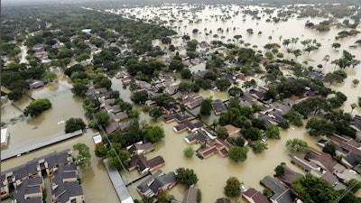 Water from the Addicks Reservoir flows into neighborhoods from floodwaters brought on by Tropical Storm Harvey in Houston, Aug. 29, 2017.