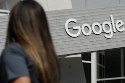 A woman walks below a Google sign on the company's campus in Mountain View, Calif., Sept. 24, 2019.