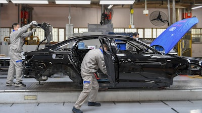 Workers assemble Audi A6 L cars at a workshop of FAW-Volkswagen Automobile Co., Ltd. in Changchun, China, Feb. 17, 2020.