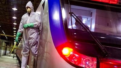 Workers disinfect subway trains against coronavirus in Tehran, Feb. 25, 2020.