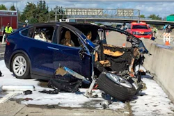 Emergency personnel work at the scene where a Tesla SUV crashed into a barrier on U.S. Highway 101 in Mountain View, Calif., March 23, 2018.