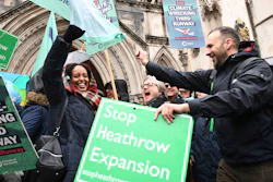 Campaigners cheer outside the Royal Courts of Justice in London, Feb. 27, 2020.
