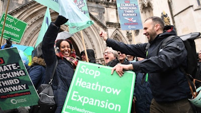 Campaigners cheer outside the Royal Courts of Justice in London, Feb. 27, 2020.