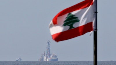 A Lebanese flag in the wind as the drilling ship Tungsten Explorer is seen off the coast of Beirut, Feb. 27, 2020.