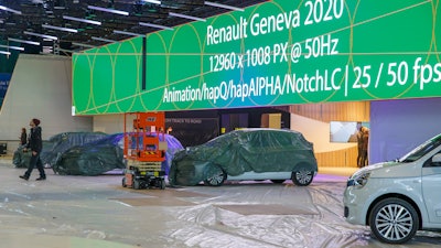 Workers stop the preparation of the 90th Geneva International Motor Show at Palexpo in Geneva, Feb. 28, 2020.