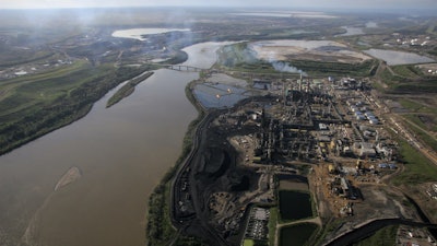 Aerial view of the Athabasca River running through oil sands developments in Alberta, June 25, 2008.