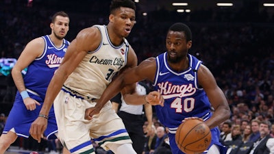 Sacramento Kings forward Harrison Barnes drives against Milwaukee Bucks forward Giannis Antetokounmpo, Jan. 10, 2020.