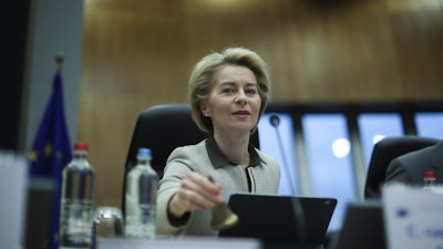 European Commission President Ursula von der Leyen rings a bell to signal the start of a weekly College of Commissioners meeting at the EU headquarters in Brussels, Feb. 26, 2020.