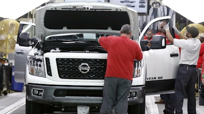 Technicians inspect vehicles on the assembly line at the Nissan Canton Assembly Plant in Canton, Miss., March 19, 2018.