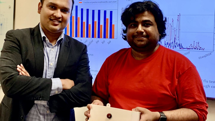 Tauhidur Rahman, left, and Forsad Al Hossain display their FluSense device.