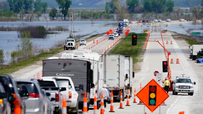 Vehicles await their turn to cross the single-lane bridge over the Missouri River on Highway 2 near Percival, Iowa, May 10, 2019.