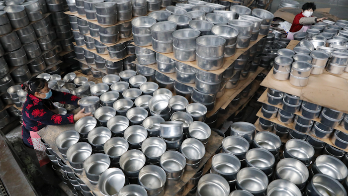 Workers arrange stew pots at a factory in Hangzhou, China, Feb. 27, 2020.