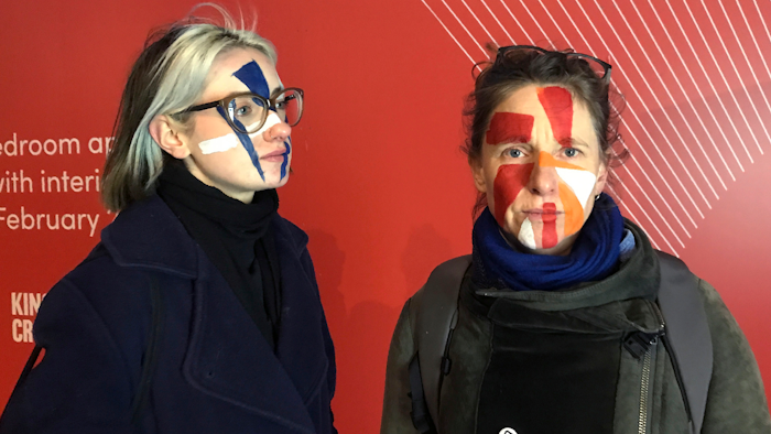 Artists Georgina Rowlands, left, and Anna Hart pose for a photo with their faces painted, Feb. 17, 2020.