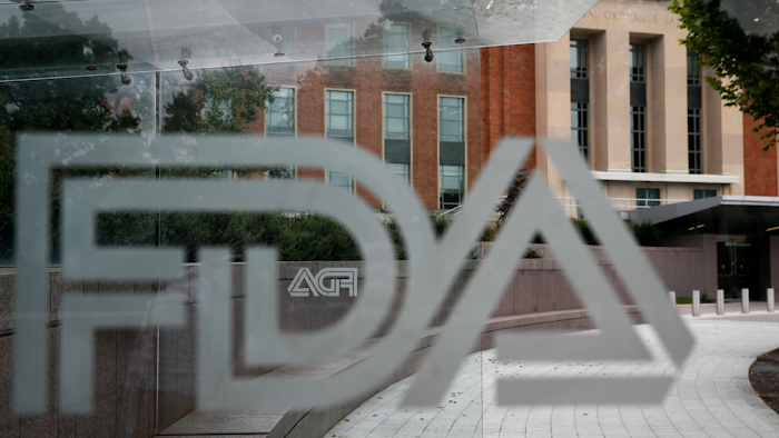The U.S. Food and Drug Administration building behind FDA logos at a bus stop in Silver Spring, Md., Aug. 2, 2018.