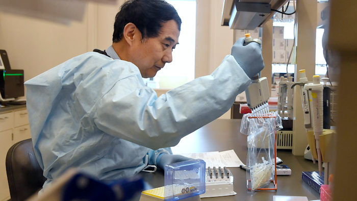 Microbiologist Xiugen Zhang runs a test at the Connecticut State Public Health Laboratory in Rocky Hill, Conn., March 2, 2020.